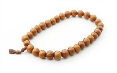 Obraz premium A set of wooden Islamic prayer beads with silver accents and a tassel Isolated on white Background