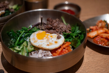 Bibimbap, a Korean rice dish. It is cooked rice mixed with namul, gochujang, egg and meat.