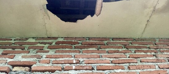 Damaged Ceiling and Exposed Brick Wall Interior