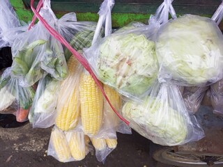 Freshly Bagged Sweet Corn and Cabbages at Local Market
