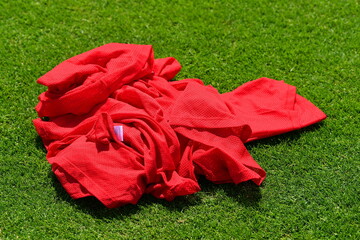 Red soccer shirts on a green pitch gras turf