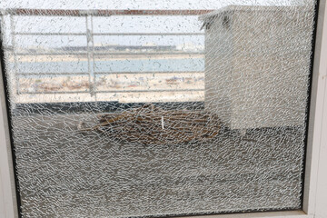 Cracked broken destroyed glass damaged window background