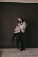mother and daughter posing in studio, family photo