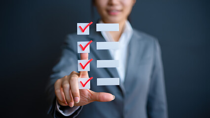 Woman in Gray Suit Interacting with Red Checkmark Checklist