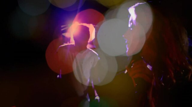 Drifting colored orbs reveal concert singer raising mic on stage and guitarist strumming