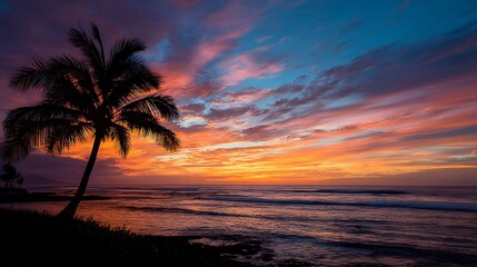 A vibrant sunset over the ocean with a silhouetted palm tree. .