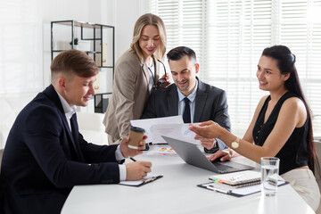 Marketing. Team of businesspeople working together at desk in office