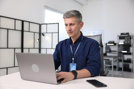 Engineer working with laptop at table in office