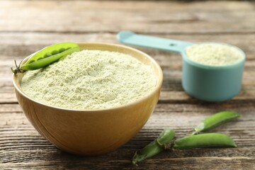 Protein powder and fresh pea pods on wooden table, closeup
