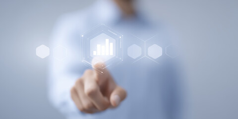 Business professional interacting with digital interface, showcasing data analytics and statistics, with a blurred background emphasizing technology and innovation in modern workplaces