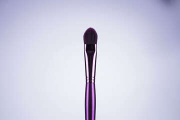 Purple Blending Eyeshadow Brush with Soft Bristles for Makeup Application on a White Background