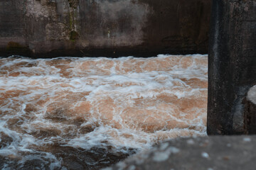 Dam of small hydroelectric power station, water discharge through locks