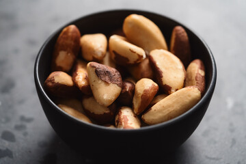 brazil nuts in black bowl on terrazzo countertop