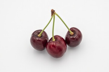 Fresh ripe dark red cherries with stalks, on white background