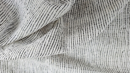 Textile Textures: Explore the intricate folds and captivating pattern of a fabric sample, an abstract symphony of texture, shadow, and light. 