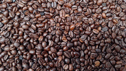 Roasted Coffee Beans: A rich tapestry of dark roasted coffee beans, each one displaying its unique shape and shade, creating a visually captivating texture and aroma.