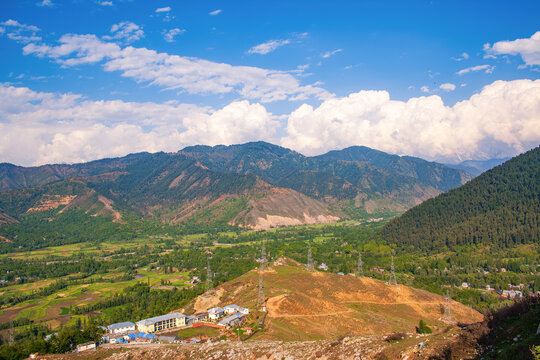 Beautiful Landscape of Kashmir Valley as Seen from Titanic View Point near Jawahar Tunnel &ndash; Scenic Himalayan Valley, Green Fields, Forested Mountains and Cloudscape under Blue Sky