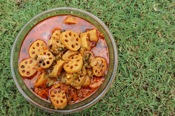 Tasty Kamal kakadi or Lotus stem curry. Lotus stem food homemade served in transparent bowl with nature background