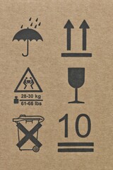 Warning labels packaging symbols silhouette shapes umbrella glass arrows this way up fragile keep dry height limit two person carry transportation logistics instructions.