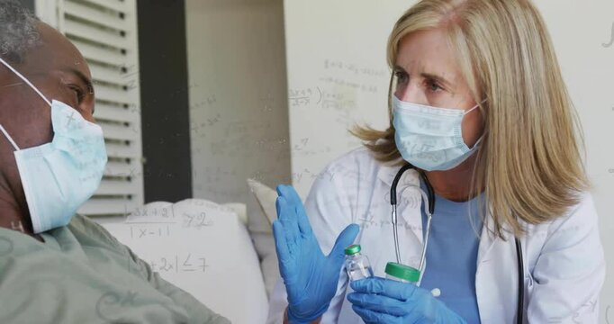 Healthcare provider arriving at patient and rotating green-capped vials for medication prep