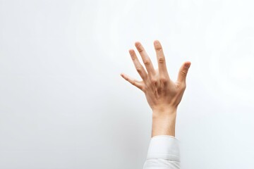 Fototapeta premium A hand reaching up, symbolizing dreams and drive in a simple studio scene.