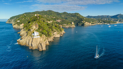 Aerial view of the historic Faro di Portofino lighthouse in Portofino, Italy.