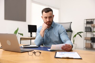 Handsome man working at desk in office
