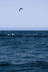 Kitesurfer surfing the waves in Rosas, Costa Brava, Spain