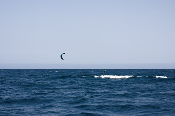 Kitesurfer surfing the waves in Rosas, Costa Brava, Spain