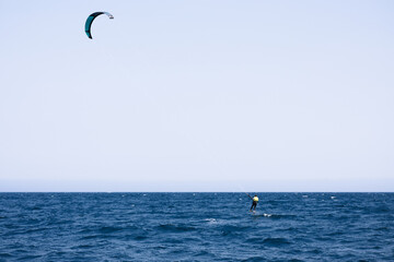 Senior Kitesurfer practicing kitesurfing with hydrofoil in Rosas, Costa Brava, Spain