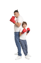Father and his son in boxing gloves on white background