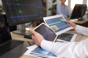 Stock exchange. Man working at desk in office, closeup
