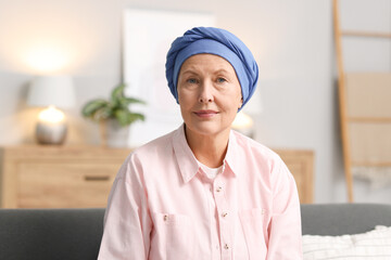 Senior woman with cancer on sofa at home