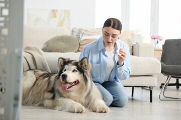 Woman suffering from allergy with her dog at home