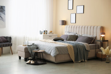 Comfortable bed with soft linens and blankets in room. Home textile