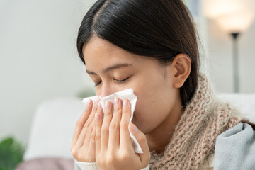 sick woman with a headache sitting under blanket, female sneezing and runny nose with seasonal influenza, allergic, high fever and influenza, resting, virus, coronavirus, feel illness, respiratory