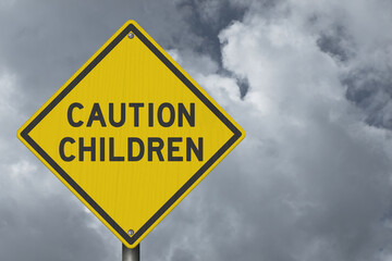 Caution Children yellow warning sign with stormy cloudy sky