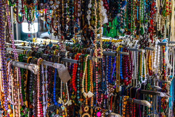 Vibrant assortment of colorful beaded necklaces on display at market stall