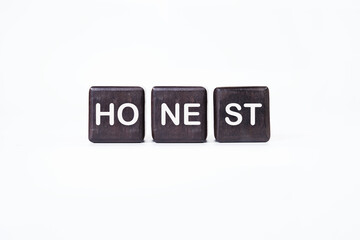 The concept word HONEST is assembled from cubes. Business integrity ethics honesty respect concept