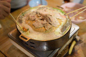 Close up of people eating Thai Food BBQ Grill Mu Kratha at night