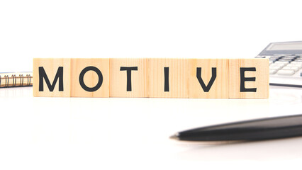The concept word MOTIVE is assembled from wooden cubes. business motivational concept