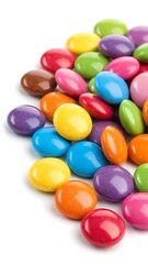 Colorful candy coated chocolate buttons on white background
