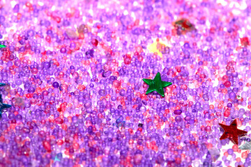 Close up of confetti tinsel glitter and shining stars on white background
