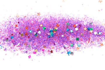 Close up of confetti tinsel glitter and shining stars on white background