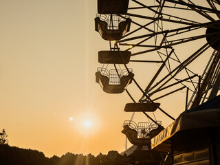 Ferris wheel gondolas waiting at sunset in amusement park