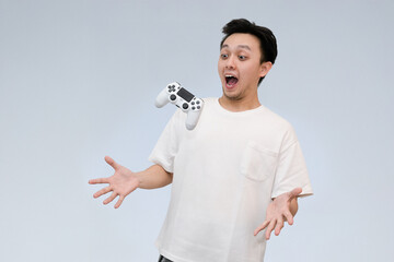 young asian man accidentally drop game controller in studio background