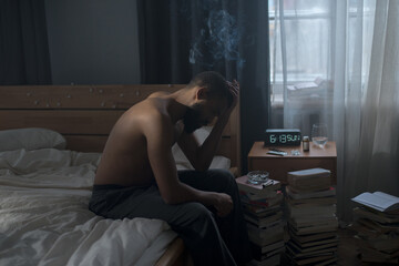 Young man smokes cigarette embodying psychological struggle