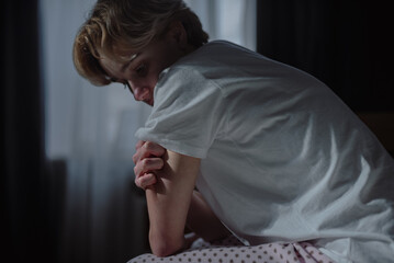 Young blonde woman feels anxious and emotional pain, suffers from depression episode