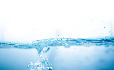 Crystal-clear splash of blue water with air bubbles and motion in a white background. Ideal for...