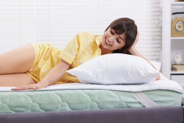 Beautiful woman lying on bed at home